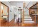 Bright foyer with hardwood floors, a staircase, and decorative accents at 8661 Laurel Grove Ln, North Charleston, SC 29420