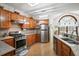 Charming kitchen featuring wood cabinets, granite countertops, and stainless steel appliances at 8661 Laurel Grove Ln, North Charleston, SC 29420
