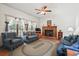 Cozy living room features a brick fireplace, ceiling fan, and comfortable seating area at 8661 Laurel Grove Ln, North Charleston, SC 29420