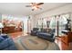 Comfortable living room features ceiling fan, fireplace and view to the kitchen at 8661 Laurel Grove Ln, North Charleston, SC 29420