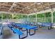 Covered picnic area with multiple blue picnic tables, ideal for outdoor dining and community gatherings at 8661 Laurel Grove Ln, North Charleston, SC 29420
