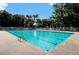 Large community swimming pool with clear blue water, surrounded by lounge chairs and umbrellas at 8661 Laurel Grove Ln, North Charleston, SC 29420