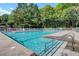 Outdoor pool with clear blue water, surrounded by lounge chairs, offering a relaxing and refreshing amenity at 8661 Laurel Grove Ln, North Charleston, SC 29420
