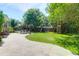Inviting backyard with patio seating, lush lawn, mature trees, a fire pit, and a playhouse at 1001 Foxcroft Rd, James Island, SC 29412