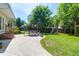Outdoor patio with seating, a well-manicured lawn, mature trees, and backyard play equipment at 1001 Foxcroft Rd, James Island, SC 29412