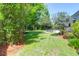 Beautiful backyard featuring a lush lawn and mature trees at 1001 Foxcroft Rd, James Island, SC 29412