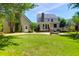 Property showcasing a lush yard, patio seating, and a detached building with a spiral staircase at 1001 Foxcroft Rd, James Island, SC 29412