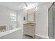 Well-lit bathroom features a vanity, mirror, and combination tub/shower at 1001 Foxcroft Rd, James Island, SC 29412