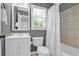 Bathroom featuring a white vanity, toilet, shower with tile surround and a window for natural lighting at 1001 Foxcroft Rd, James Island, SC 29412