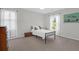 Neutral bedroom with a black frame bed, hardwood floors, and natural light at 1001 Foxcroft Rd, James Island, SC 29412