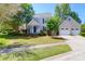 Charming two-story home with a well-manicured lawn and attached two-car garage at 1001 Foxcroft Rd, James Island, SC 29412