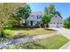 Charming two-story home with attached garage and a well-manicured front yard on a sunny day at 1001 Foxcroft Rd, James Island, SC 29412