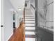 Bright foyer featuring hardwood floors and staircase, creating a welcoming entrance to the home at 1001 Foxcroft Rd, James Island, SC 29412