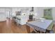 Open concept kitchen with white cabinets, an island with seating, and hardwood floors, perfect for Gathering living at 1001 Foxcroft Rd, James Island, SC 29412