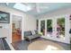 Versatile sunroom with tiled floors, skylight, piano, and view to the backyard at 1001 Foxcroft Rd, James Island, SC 29412