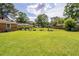 A large, green backyard is perfect for outdoor enjoyment and gardening at 104 Clover St, Summerville, SC 29483