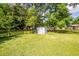 The backyard includes a storage shed, mature trees, and a well maintained lawn at 104 Clover St, Summerville, SC 29483