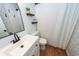 Modern bathroom with sleek vanity, stylish mirror, and shower with patterned curtain at 104 Clover St, Summerville, SC 29483