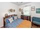 A charming bedroom features a unique color scheme, a bed with a bookcase headboard, and natural light at 104 Clover St, Summerville, SC 29483