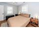 Inviting bedroom with natural light, two windows with blinds, a ceiling fan, and neutral tones for a comfortable retreat at 104 Clover St, Summerville, SC 29483
