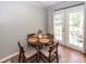Cozy dining area with a round wooden table, four chairs, and French doors to the outside at 104 Clover St, Summerville, SC 29483