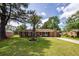 Charming single-story brick home with well-manicured lawn and mature landscaping at 104 Clover St, Summerville, SC 29483