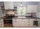 Cozy kitchen features stainless steel appliances, white cabinets and a window over the sink at 104 Clover St, Summerville, SC 29483