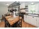 Well-appointed kitchen with white cabinetry, stainless appliances, butcher block island and adjacent dining area at 104 Clover St, Summerville, SC 29483