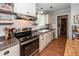 Charming kitchen with white cabinets, open shelving, and stainless steel appliances at 104 Clover St, Summerville, SC 29483