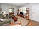Stylish living room with shelving, large window, view into the adjacent room and front door at 104 Clover St, Summerville, SC 29483