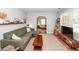 Inviting living room with green sofa, wood accents, and a view into another room at 104 Clover St, Summerville, SC 29483