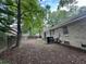 Leafy backyard with privacy fencing featuring the back of a brick home at 106 Pelican St, Ladson, SC 29456