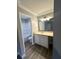 Clean bathroom with a white vanity, modern lighting, and combined tub and shower at 106 Pelican St, Ladson, SC 29456