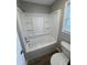 Bathroom showcasing a sleek white tub/shower and a toilet next to a bright window at 106 Pelican St, Ladson, SC 29456