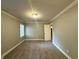 Cozy bedroom with neutral walls, plush carpet, and a window letting in natural light at 106 Pelican St, Ladson, SC 29456