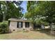 Traditional brick home featuring a well-manicured lawn and a quaint front porch at 106 Pelican St, Ladson, SC 29456