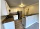 Efficient kitchen with white cabinets, stainless steel refrigerator, and sleek granite countertops at 106 Pelican St, Ladson, SC 29456
