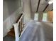 Open living space with a staircase featuring decorative wood paneling and white railings at 106 Pelican St, Ladson, SC 29456