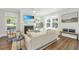 Bright living room with fireplace, large windows, hardwood floors, and comfortable seating at 109 Gray Pine Ln, Summerville, SC 29483