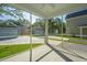 View from the screened porch overlooking a spacious backyard and neighboring houses at 109 Gray Pine Ln, Summerville, SC 29483