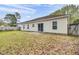 Back exterior view of the home with a large yard and small patio at 109 Wisteria Ct, Summerville, SC 29486