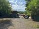 View of the backyard with a gravel driveway and trees at 111 Craven Rd, Ladson, SC 29456