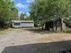 View of the backyard with a gravel driveway and two outbuildings at 111 Craven Rd, Ladson, SC 29456