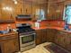 Well-equipped kitchen with stainless steel appliances, orange countertops, oak cabinets and vintage patterned flooring at 111 Craven Rd, Ladson, SC 29456
