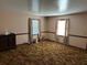 Spacious living room with carpet, two windows with blinds, and a dresser at 111 Craven Rd, Ladson, SC 29456