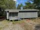 Exterior view of an outbuilding with a gray exterior and a small porch at 111 Craven Rd, Ladson, SC 29456