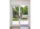 View of the backyard through open french doors, with a deck and outdoor seating at 1199 Island View Dr, Mount Pleasant, SC 29464