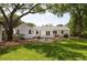 Lush backyard featuring manicured lawn, mature shade trees, patio, and a small outbuilding at 1199 Island View Dr, Mount Pleasant, SC 29464
