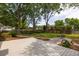Spacious backyard with a wooden deck, mature trees, green grass, and seating area at 1199 Island View Dr, Mount Pleasant, SC 29464