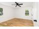 Well-lit bedroom with wood floors, two windows, and a modern ceiling fan at 1199 Island View Dr, Mount Pleasant, SC 29464